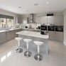 Modern kitchen with large-format polished floor tiles suitable for electric radiant floor heating installation.