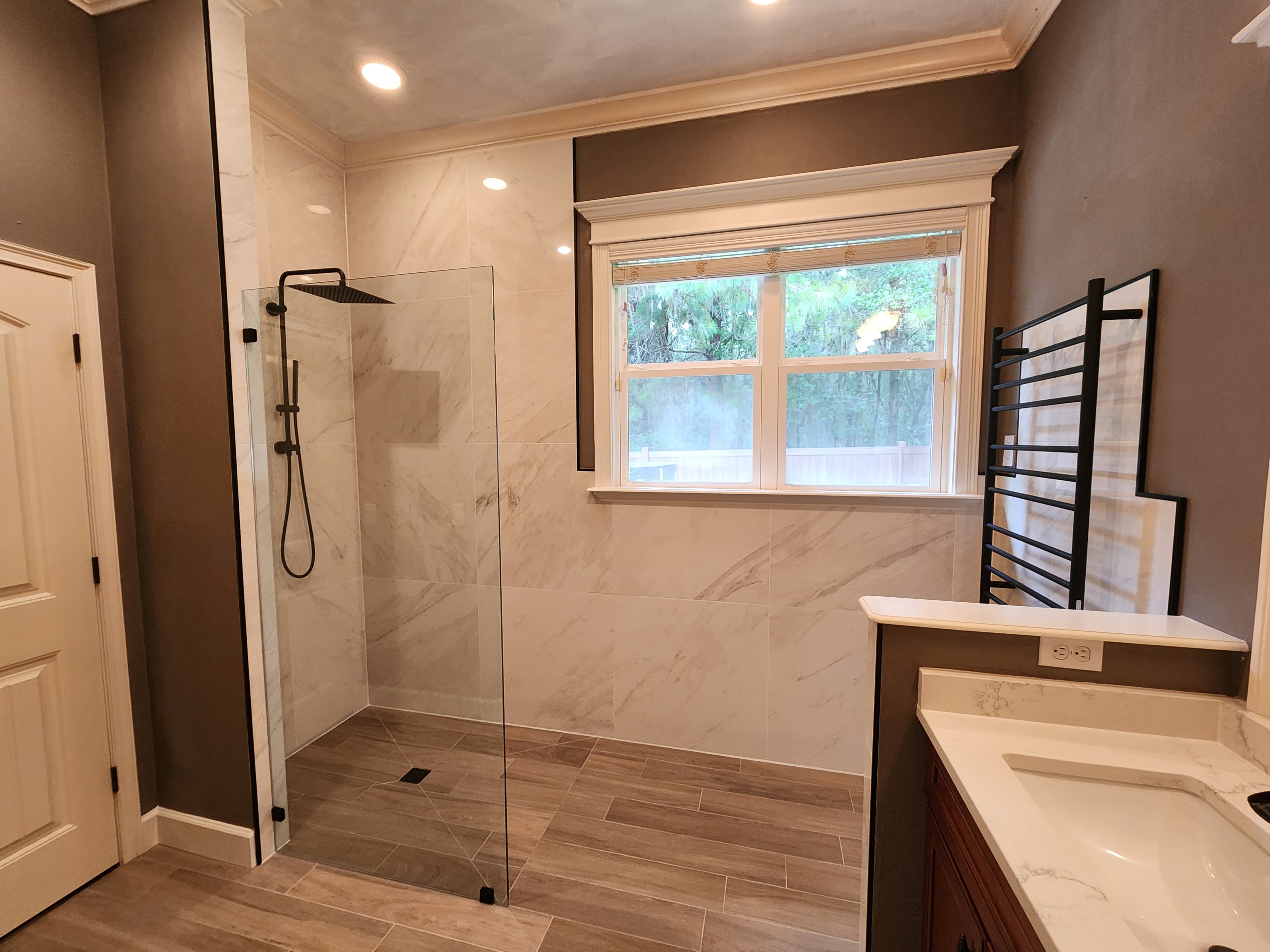 A modern wet room with a freestanding tub and open shower.