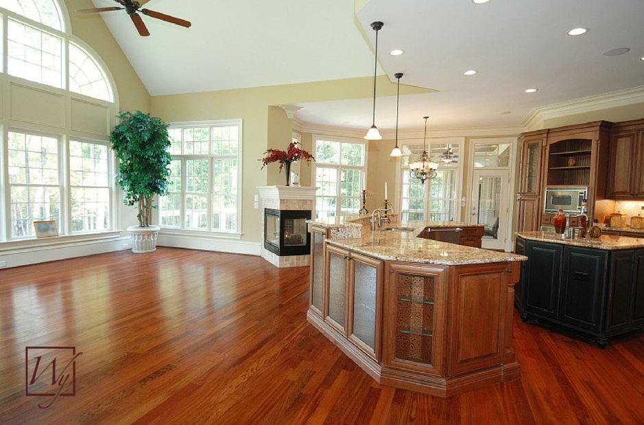 Open-concept kitchen and living area with hardwood flooring installed over an electric radiant floor heating system.