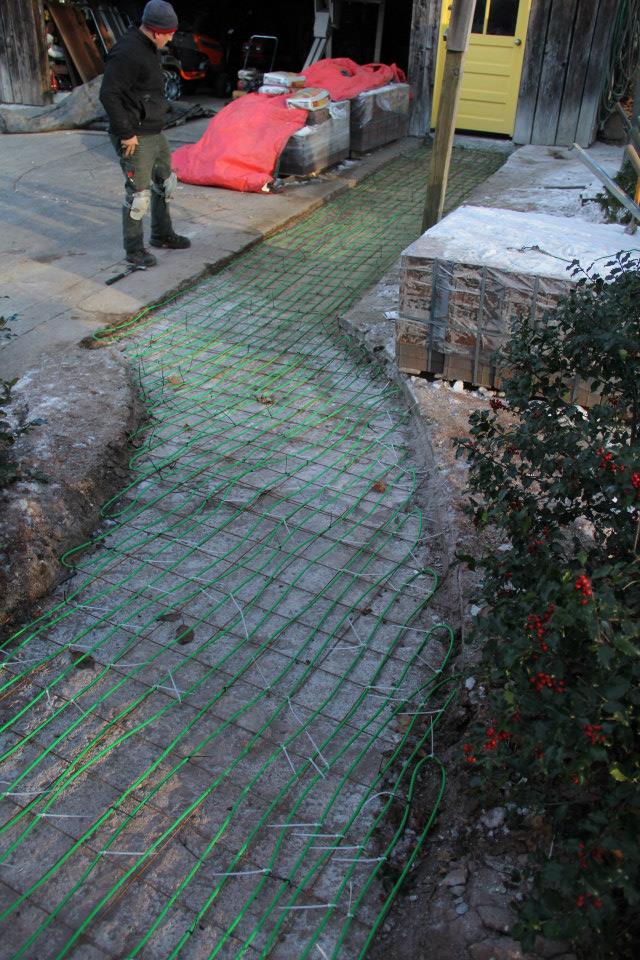 A heated outdoor pathway aids a handicapped homeowner.