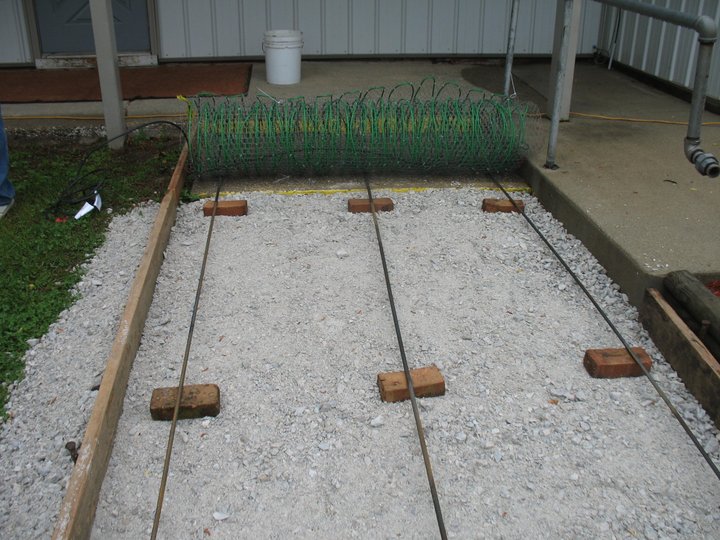 Step 3: Walkway base and rebar set before the pour, beside an existing handrail