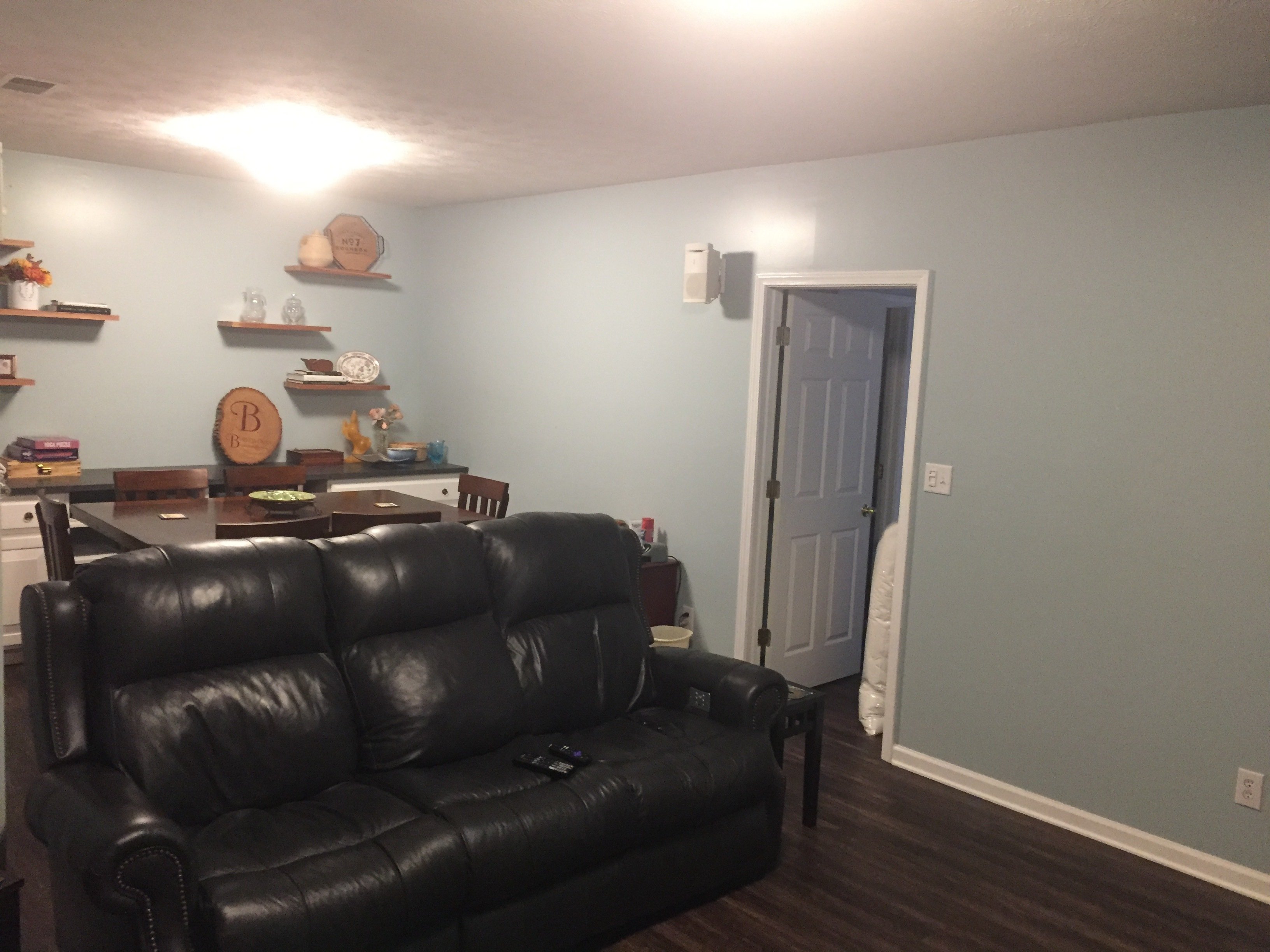 After photo of a finished media room with heated LVT floors