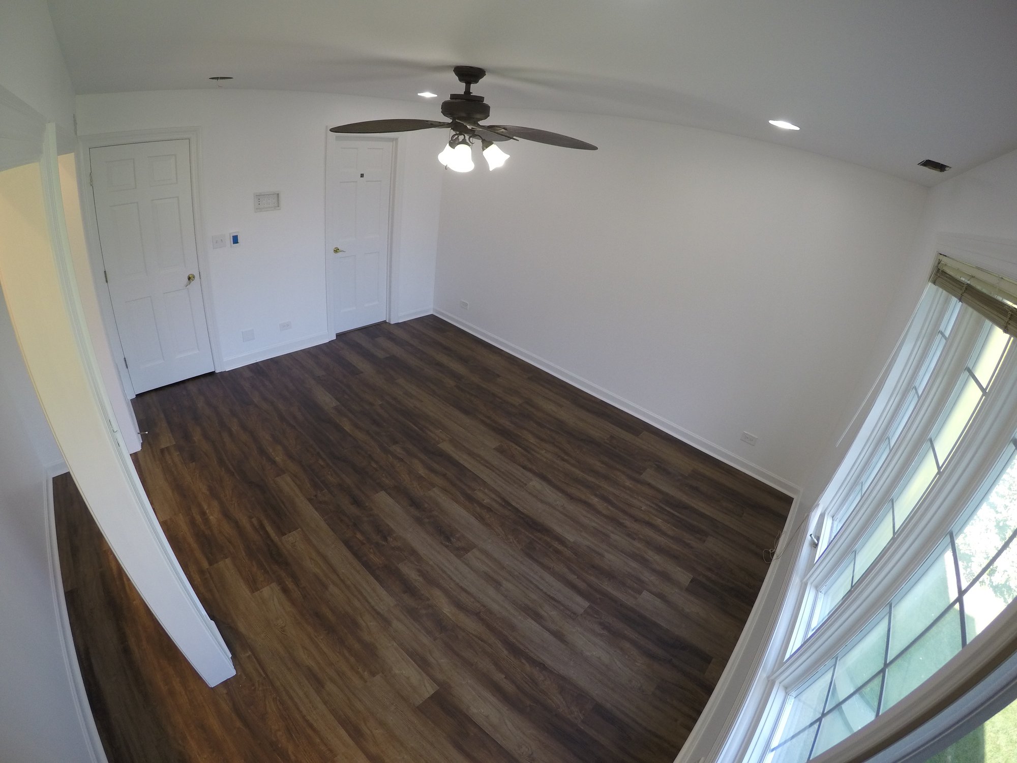 angled shot of completed bedroom with heated lvt