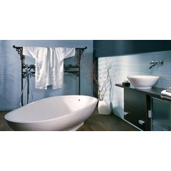 A modern Asian-inspired bathroom featuring a white freestanding bathtub and a dark wood vanity with a vessel sink.