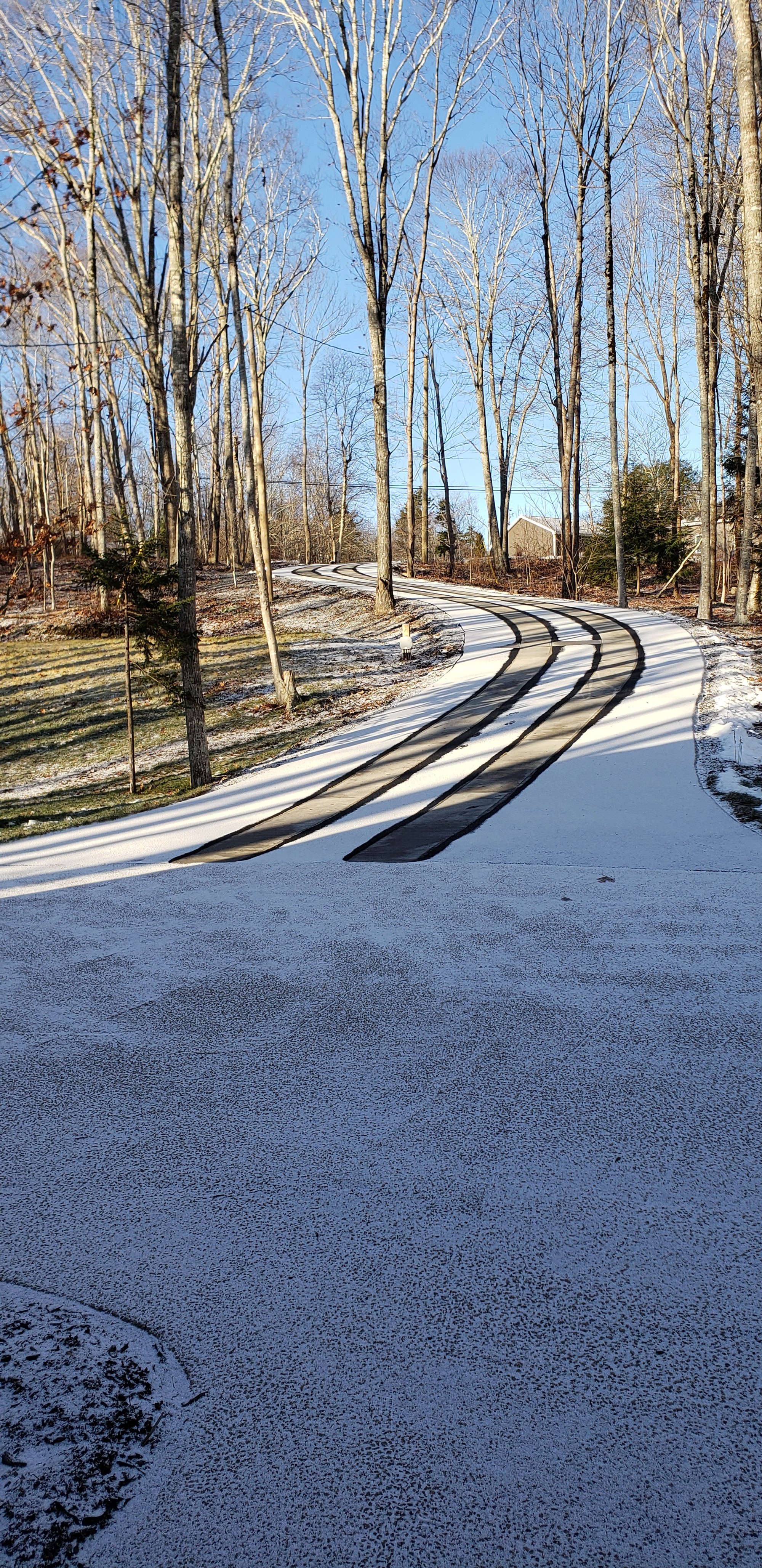 Asphalt driveway retrofit with snow melting tire tracks