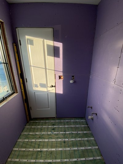 Bathroom with black and white heated tile floor installed