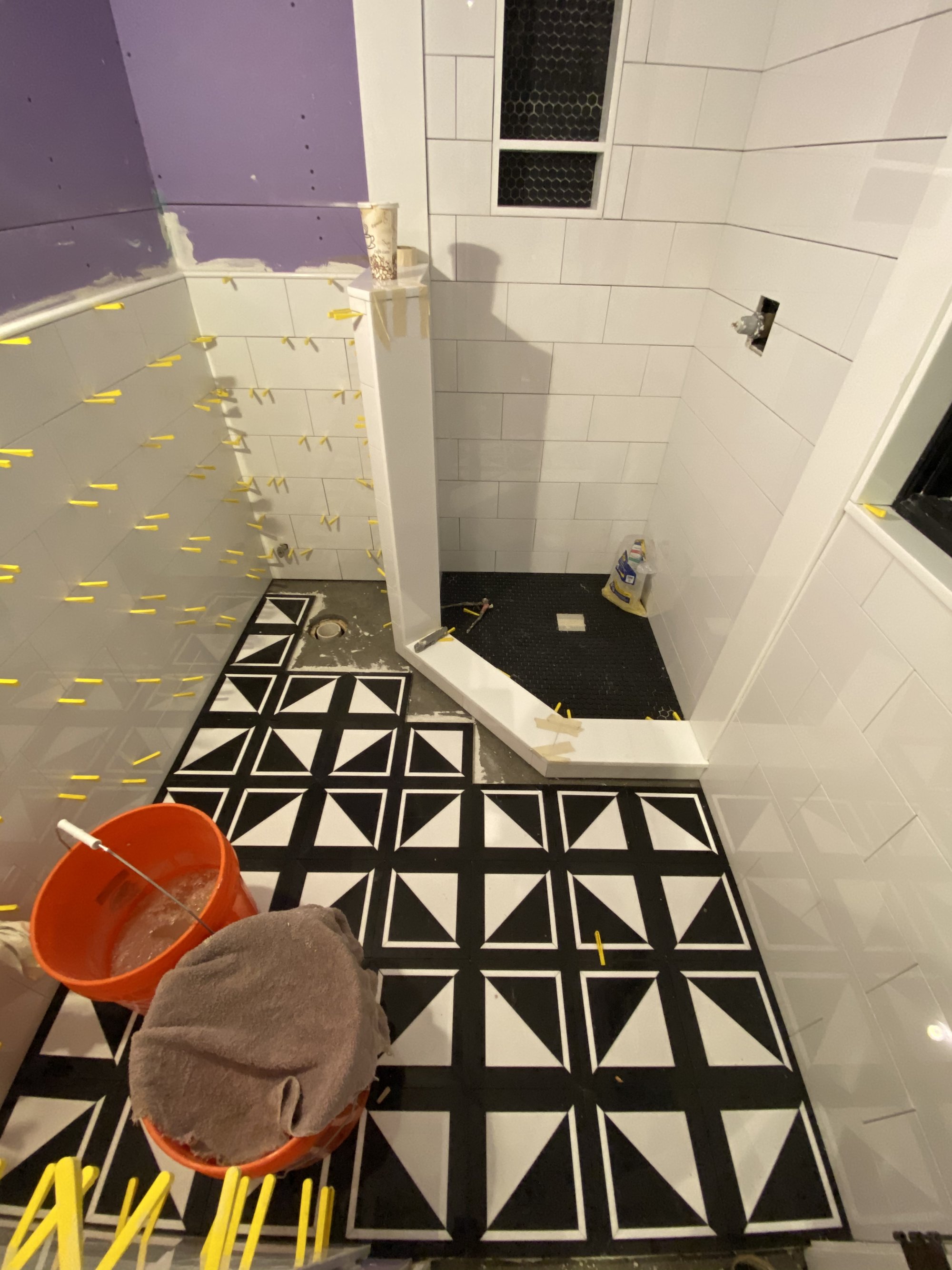 Bathroom with black and white heated tile floor for shower