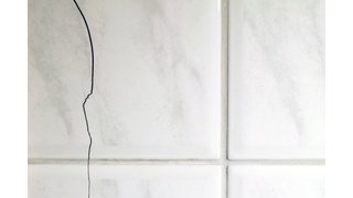 Bathroom with cracked tile floor