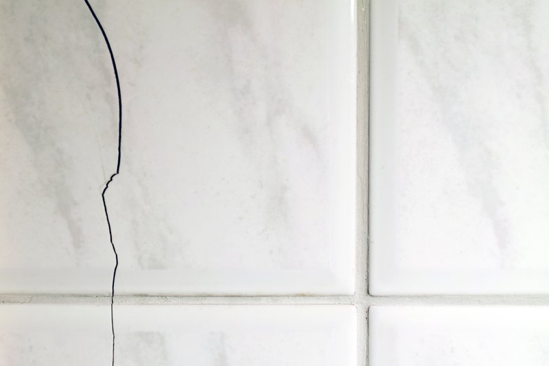 Bathroom with cracked tile floor