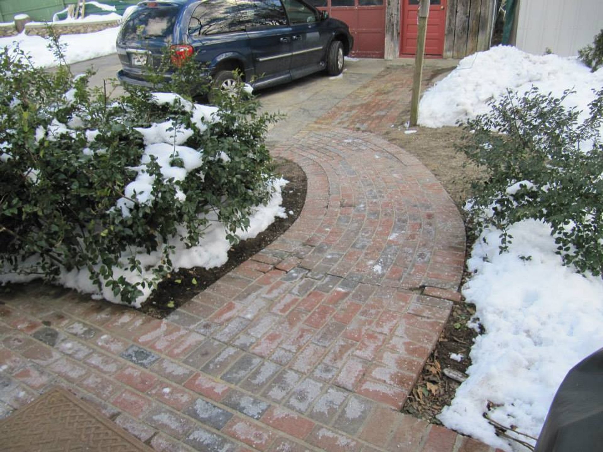 Snow-free heated wheelchair ramp and driveway in Hudson, MA showing effective snow melting system for safe winter accessibili