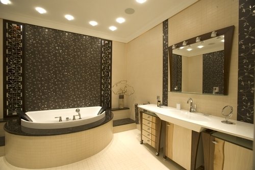 A luxury bathroom featuring a soaking tub and vanity with light-colored tile flooring suitable for electric radiant floor heating.