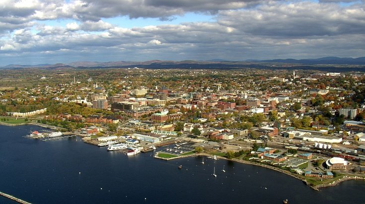 Aerial view of the Burlington, Vermont cityscape and waterfront along Lake Champlain during autumn.