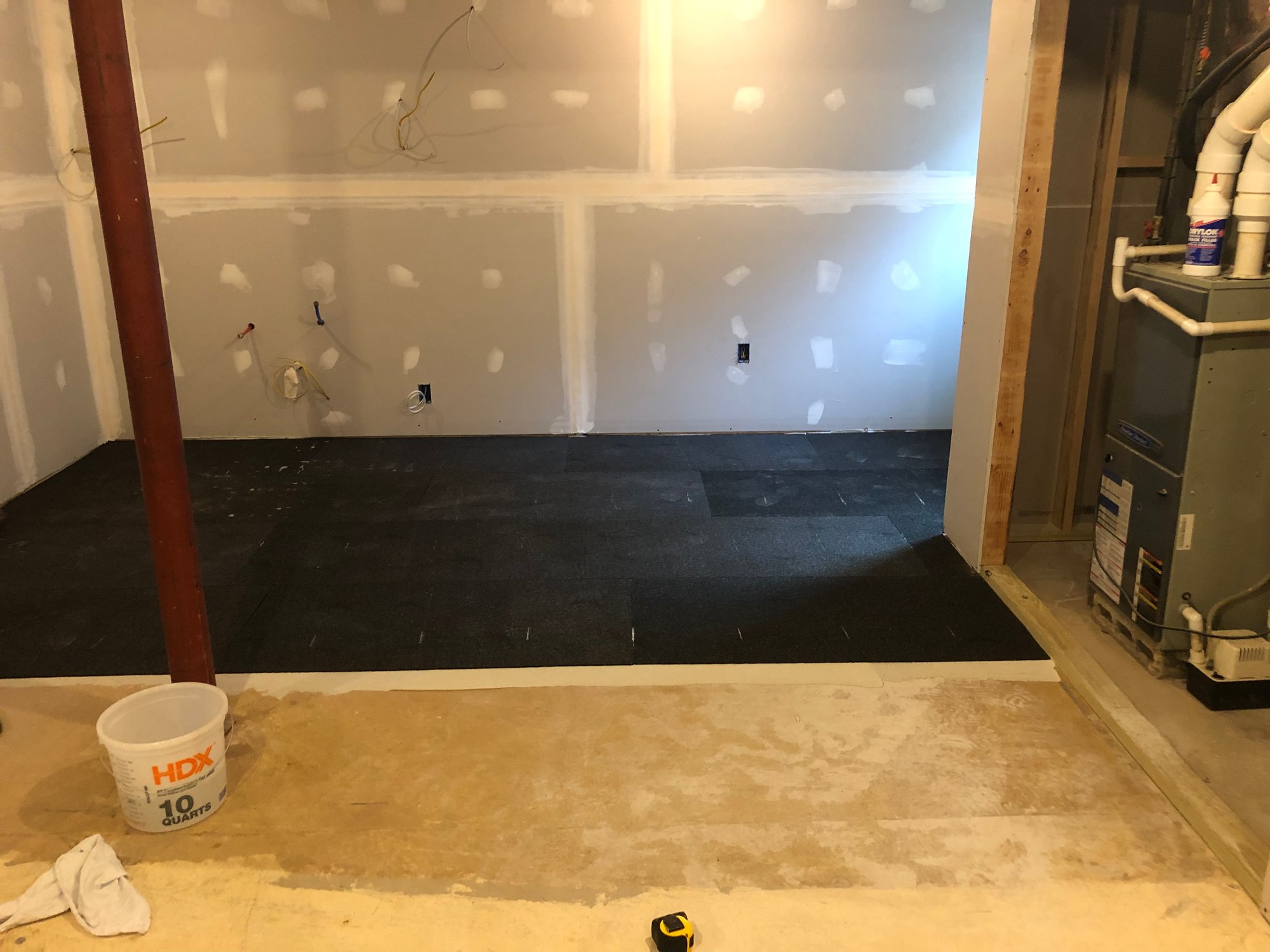 ThermalSheet underlayment being adhered to subfloor with thinset