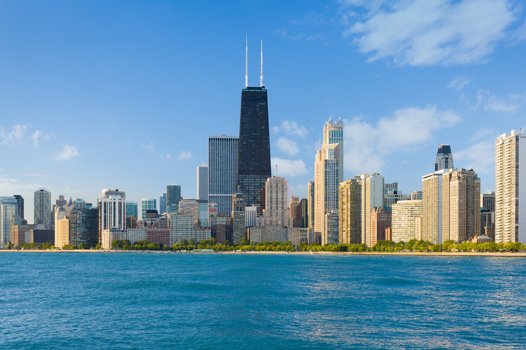 The Chicago lakefront skyline featuring the 875 North Michigan Avenue skyscraper and surrounding high-rise buildings along the shoreline.