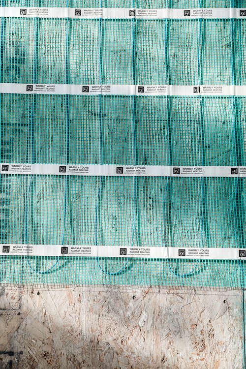Chris Loves Julia Installation of Floor Heating Under Tile for Dining Room mat close up