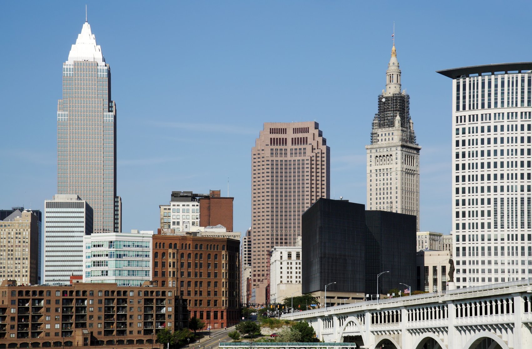The downtown Cleveland skyline featuring the Key Tower and Terminal Tower under a clear blue sky.