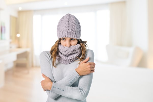 Cold woman in living room