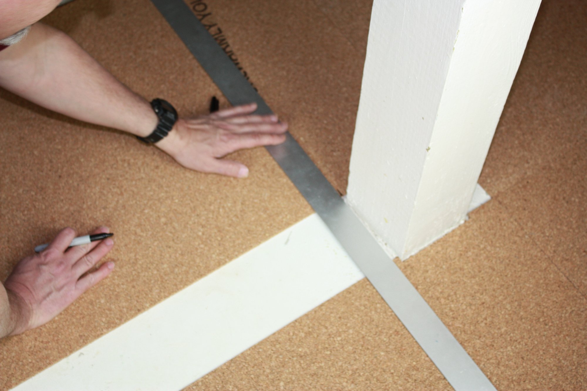 Cork underlayment installation with tempzone flex roll measuring against post