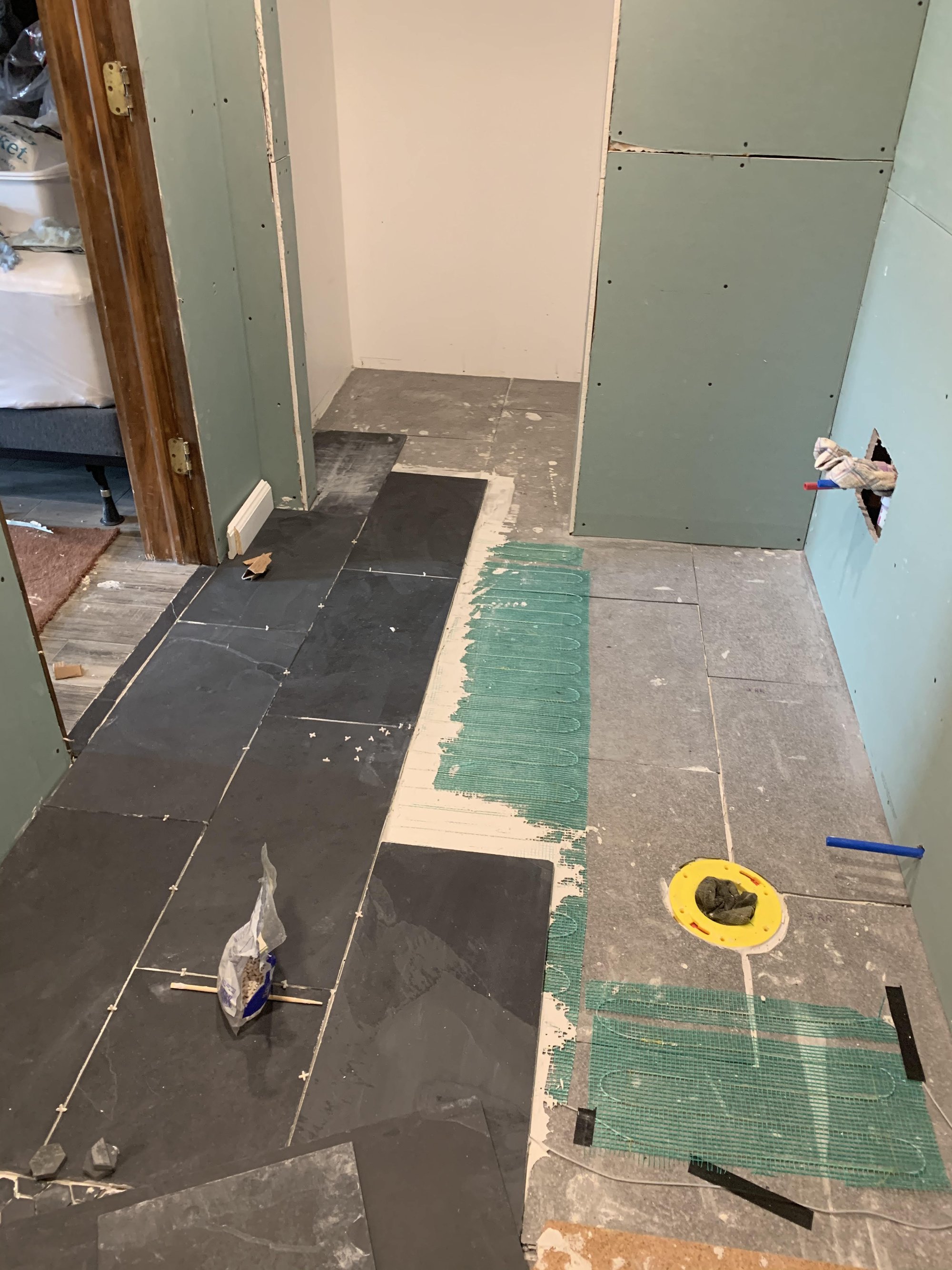 David pisano cn5241794 share your story basement bathroom tiles being laid out