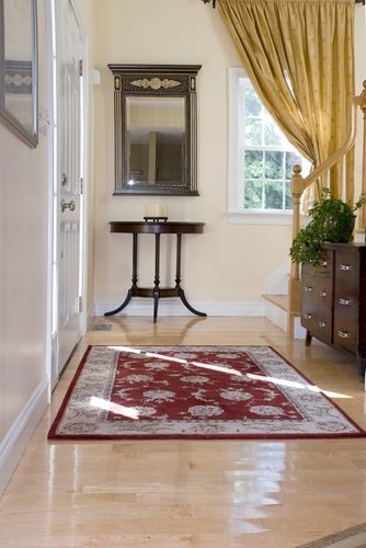 An elegant home foyer featuring light-colored hardwood flooring installed over an electric radiant floor heating system.