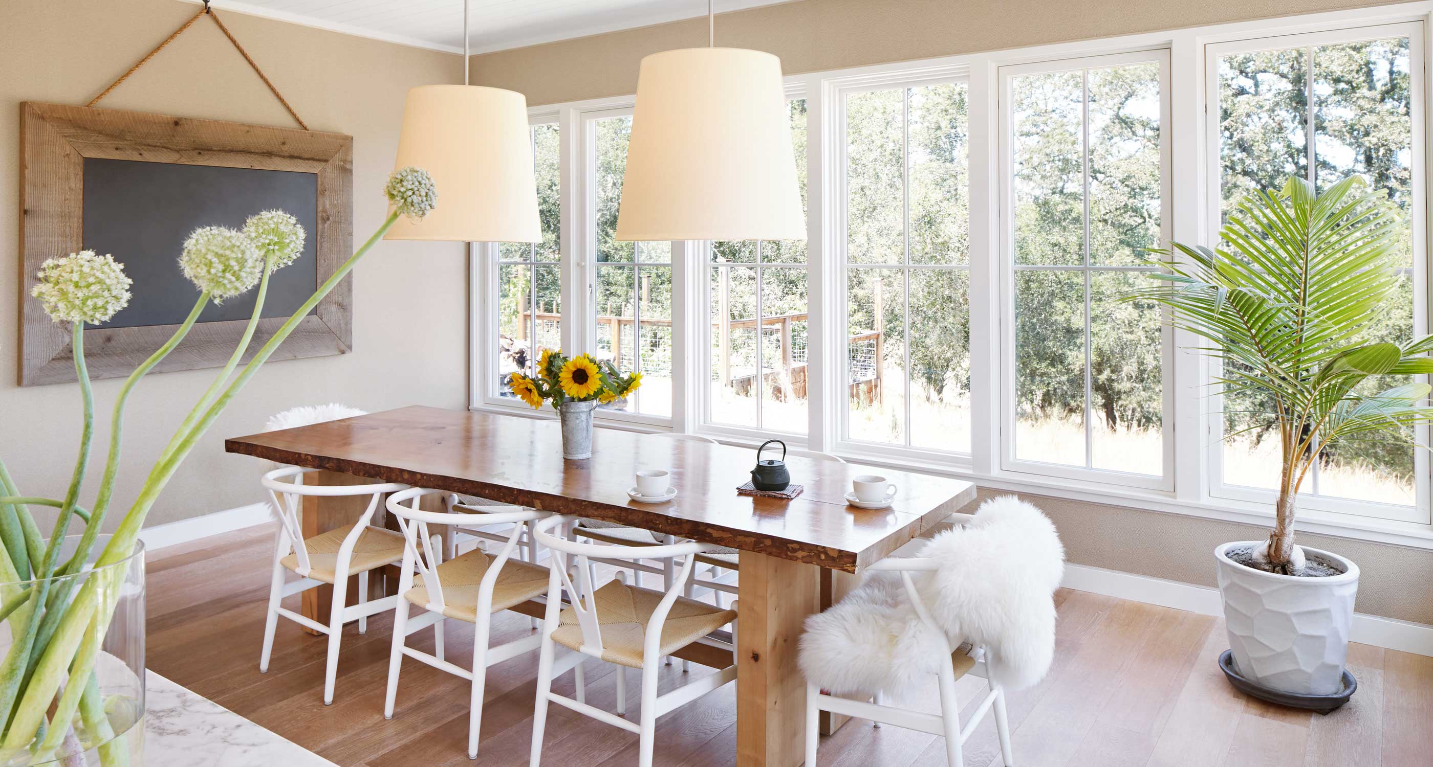 A bright dining room with light wood flooring installed over an electric radiant floor heating system.