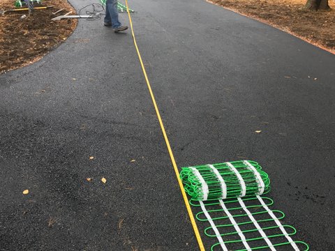 dryfitting snow melt mats on asphalt driveway Step 4: Dry-fitting the mats