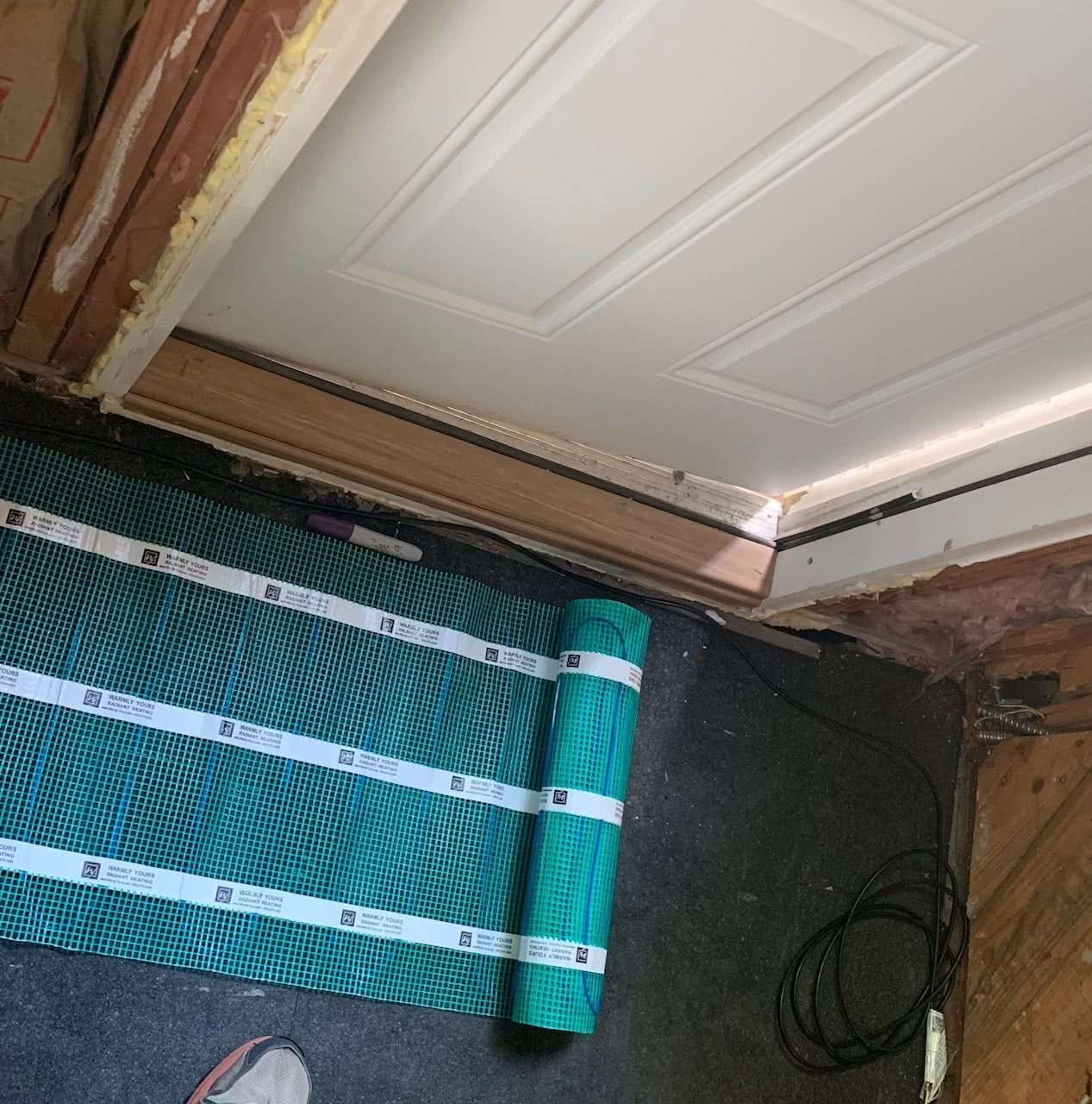 Electric floor heating installation in a mudroom with ThermalSheet and TempZone Flex Roll