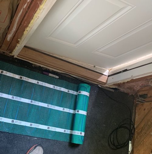Electric floor heating installation in a mudroom with ThermalSheet and TempZone Flex Roll
