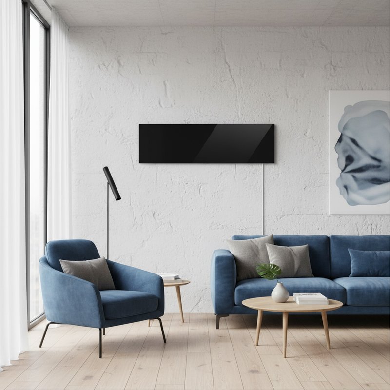 Black glass Ember radiant panel heater on white wall in modern living room with blue furniture and wood floors