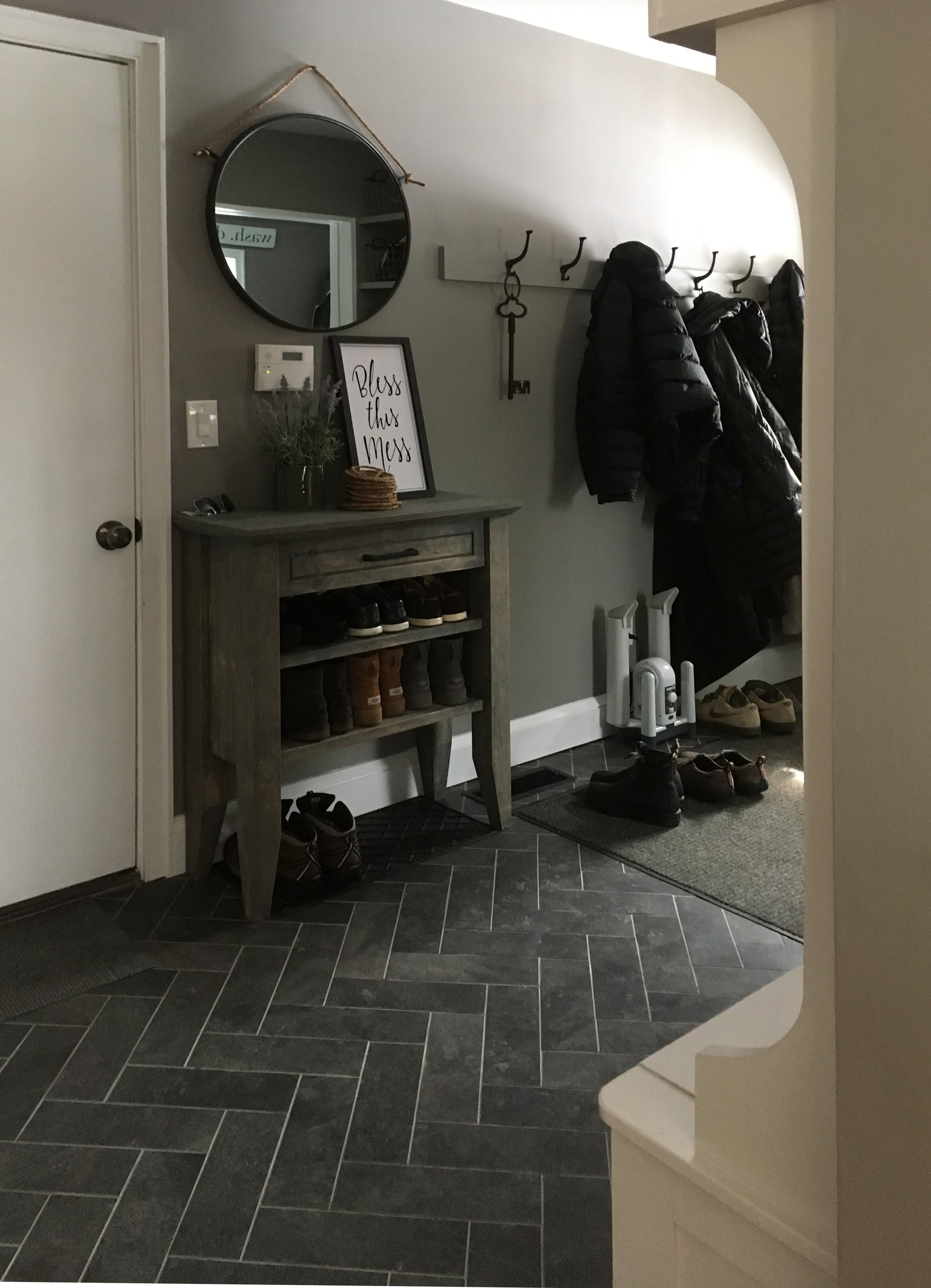 Entryway mudroom with heated tile herringbone floors