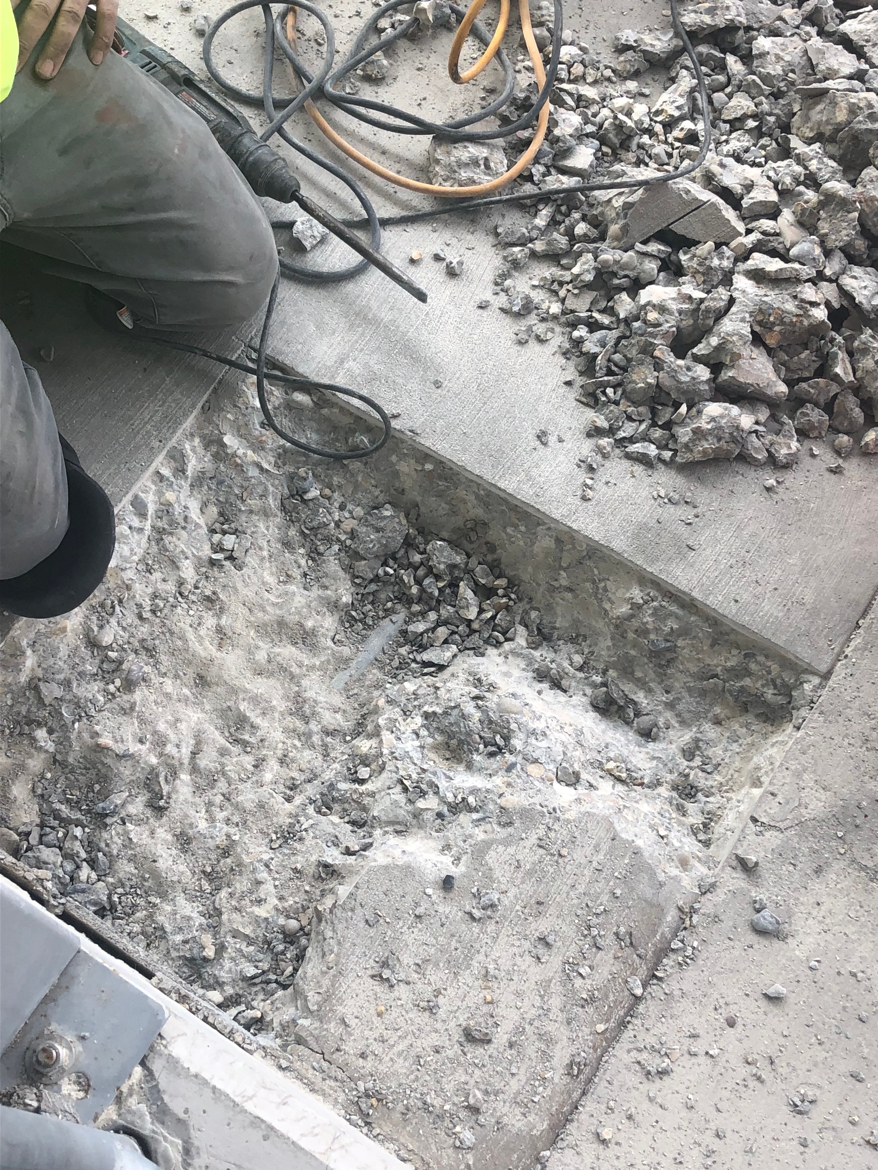 Excavating and repairing a heated driveway