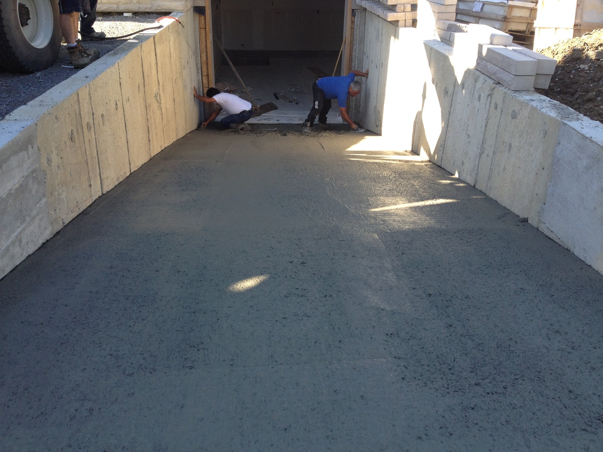 Final step for heated driveway installation in concrete smoothing concrete