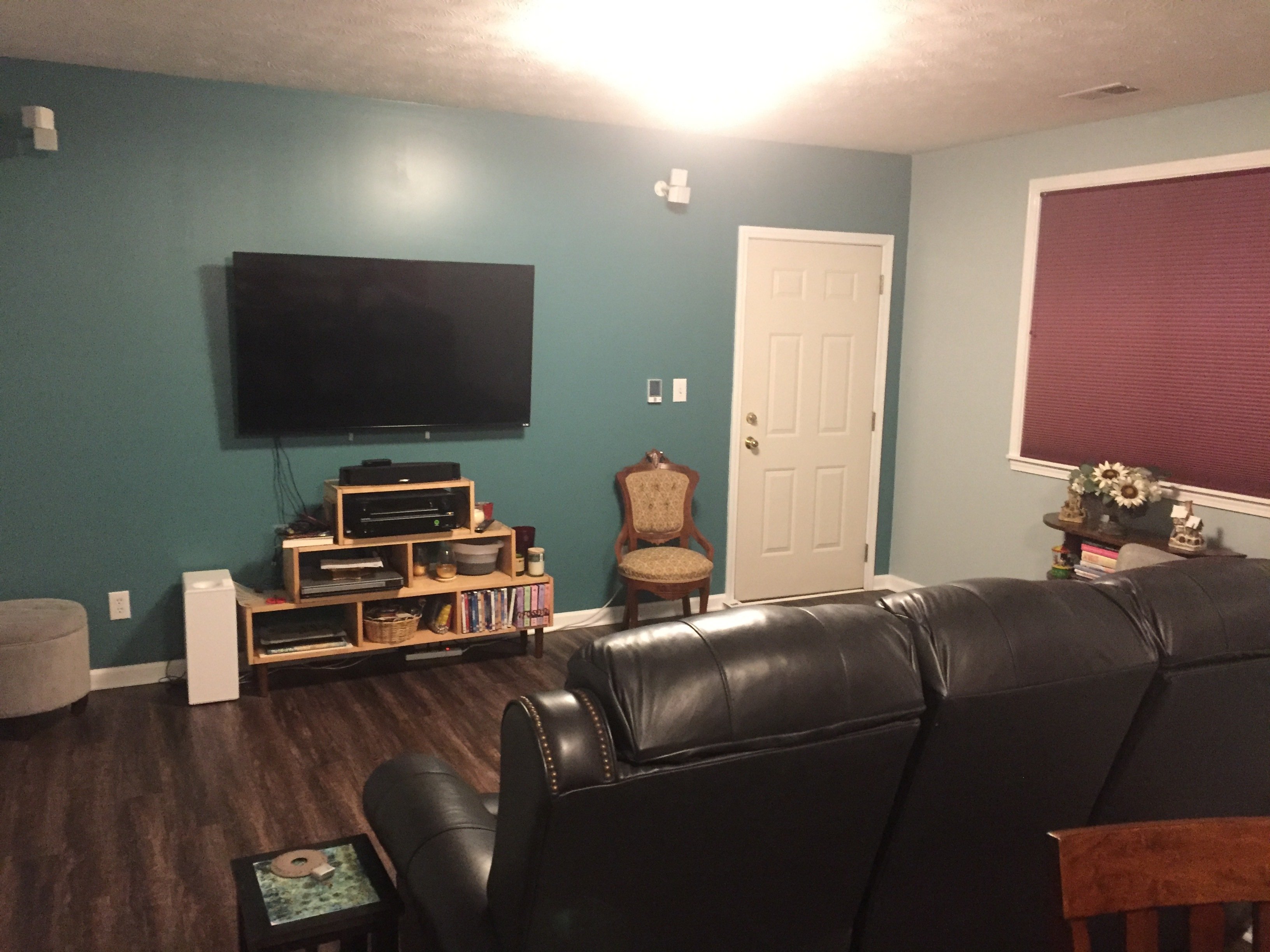 A finished media room featuring luxury vinyl tile flooring installed over an electric radiant floor heating system.