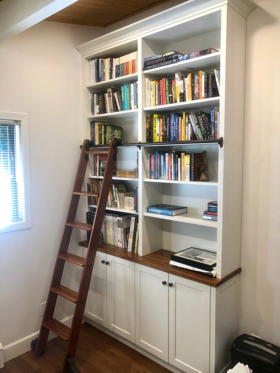 Finished den in North Vancouver with built-in bookshelves and finished wood floor heating application