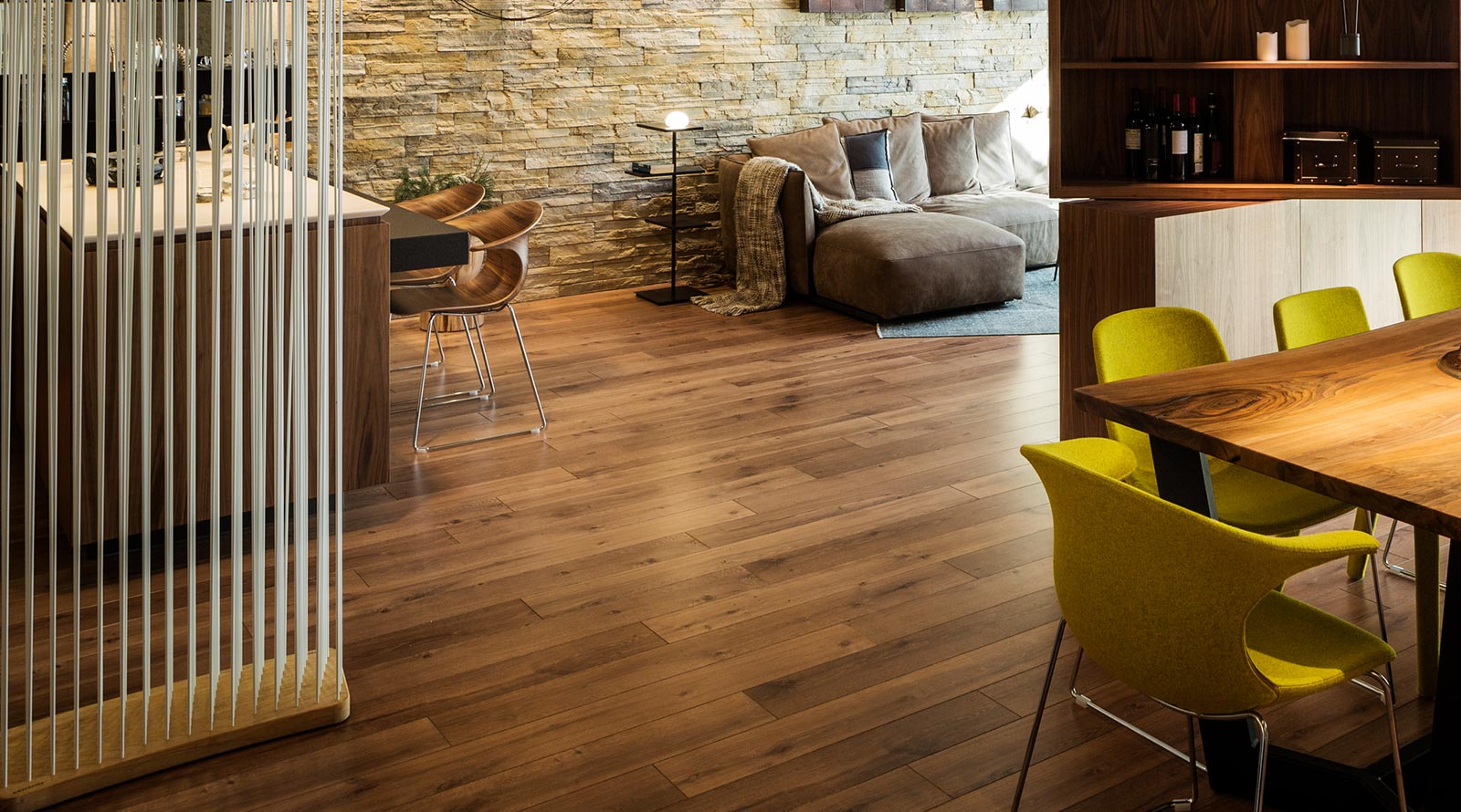 Electric radiant floor heating installed beneath wood-look flooring in an open-concept kitchen and living area.