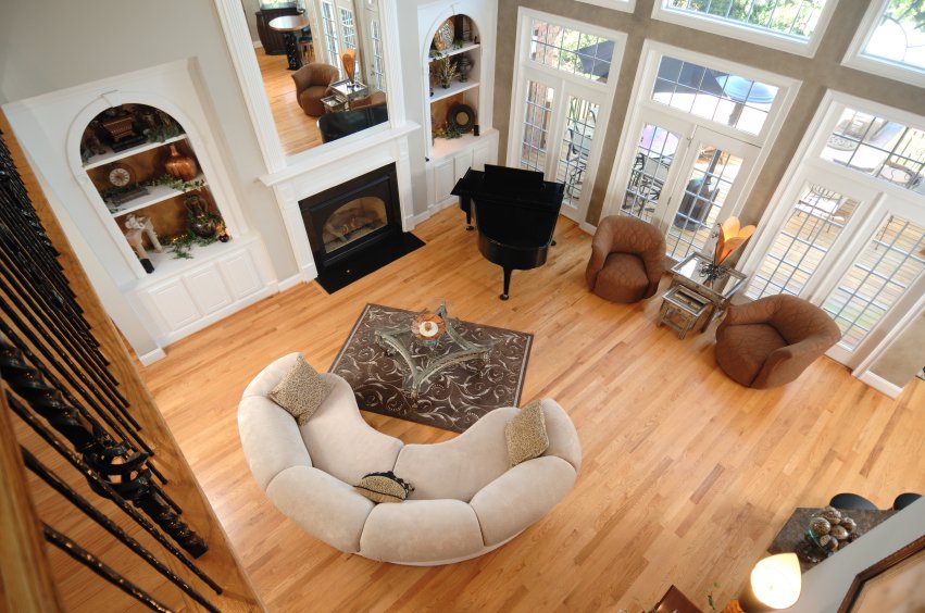A spacious living room with hardwood flooring concealing an electric radiant floor heating system.