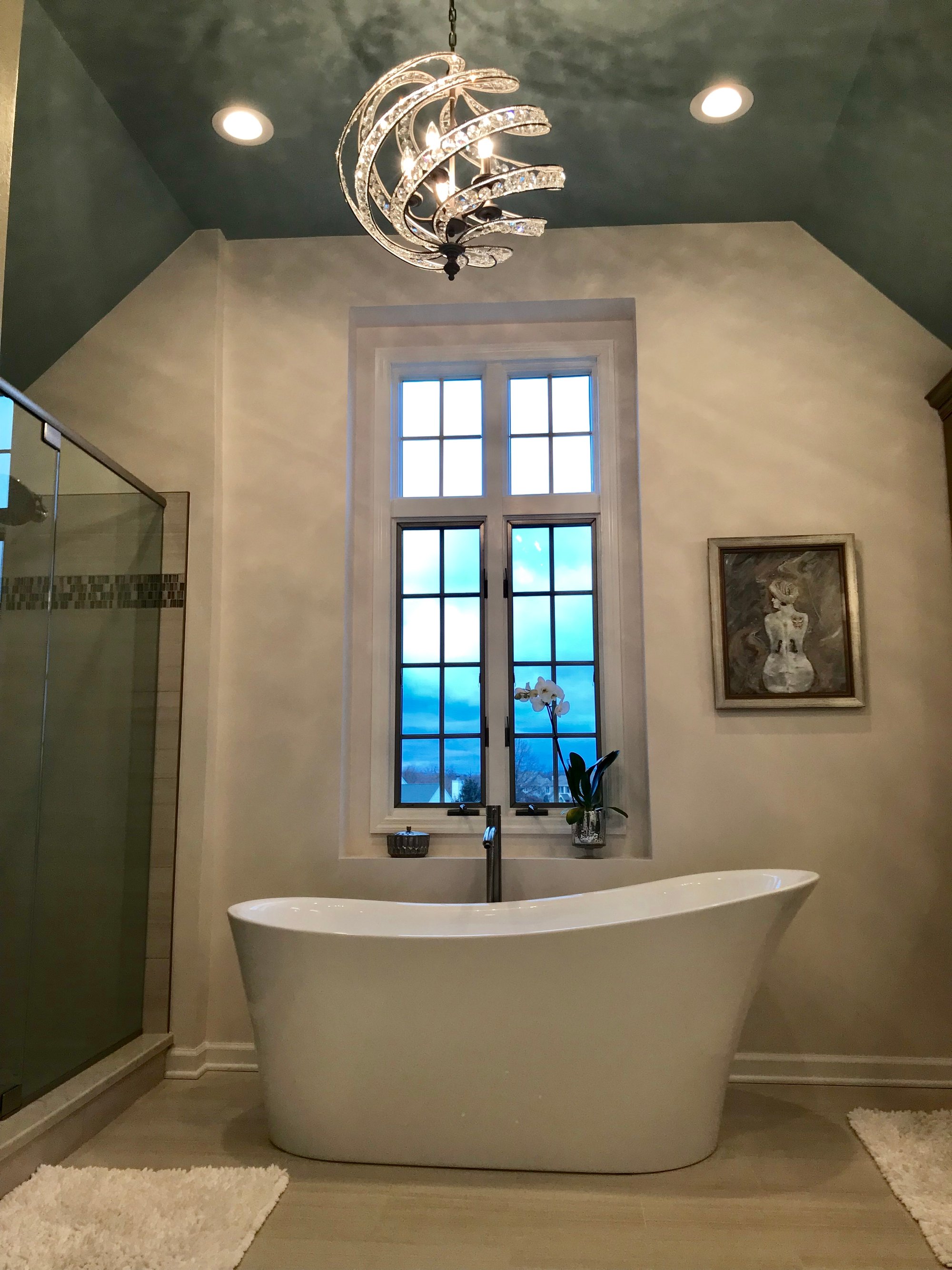 Free-standing tub in master bathroom with underfloor heating