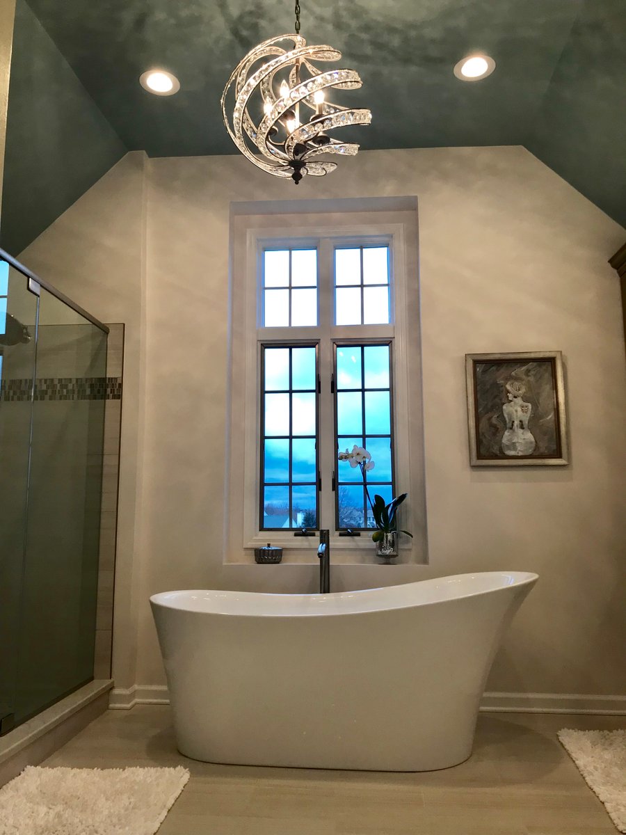 Free-standing tub in master bathroom with underfloor heating