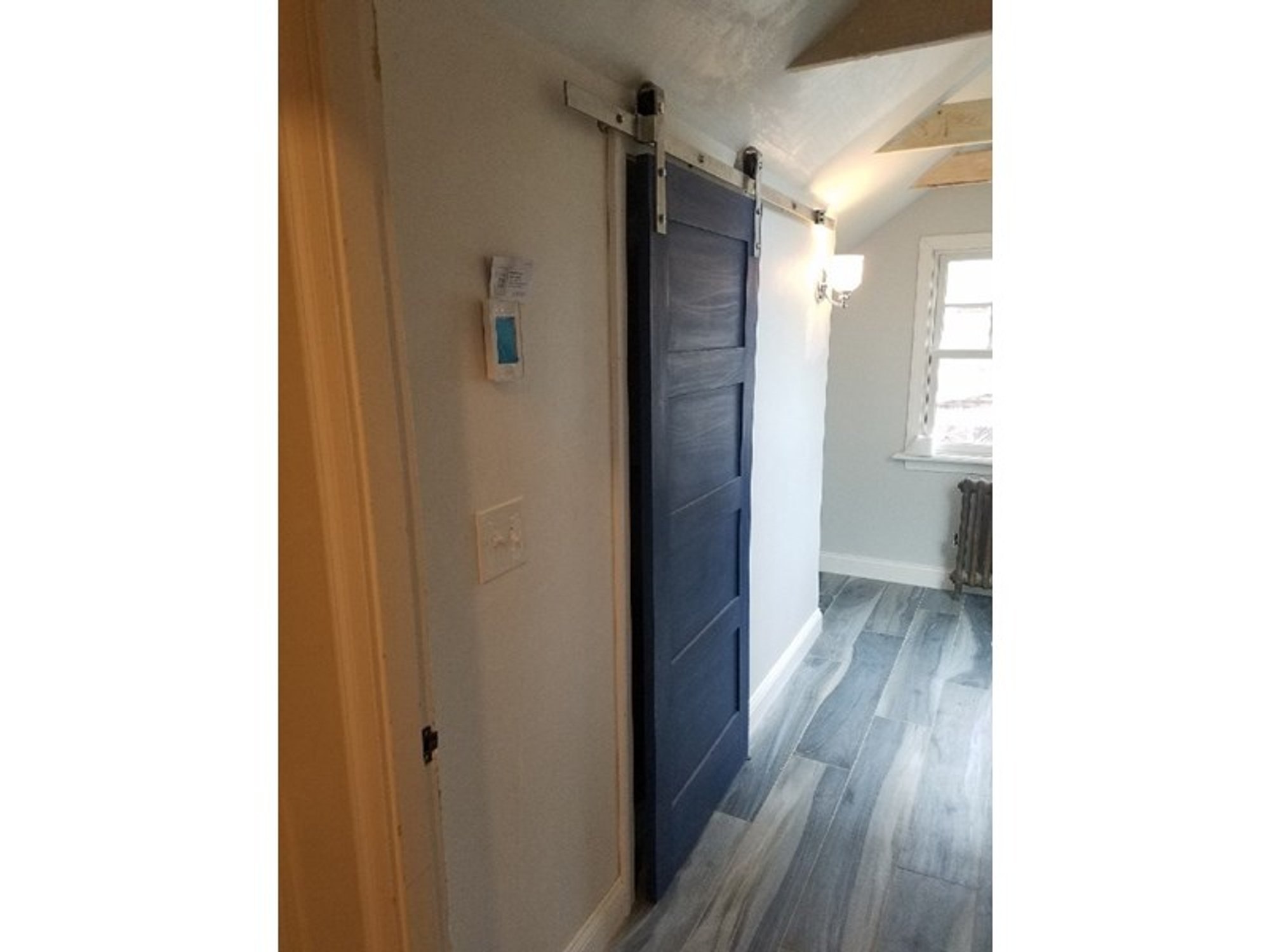 Hallway with heated tile floor and hanging barn door PROVIDENCE, RI