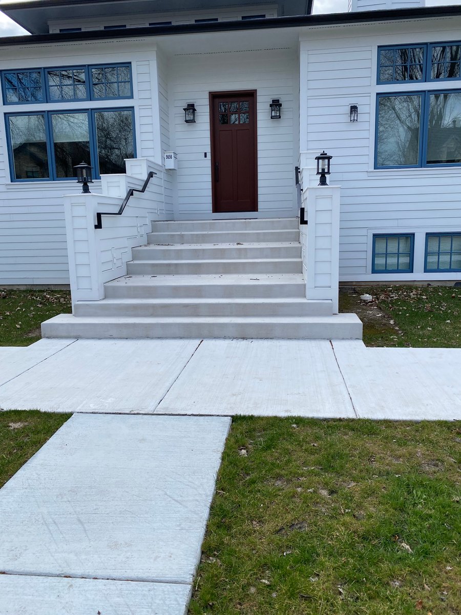 Heated concrete stairs with snow melt in front of home