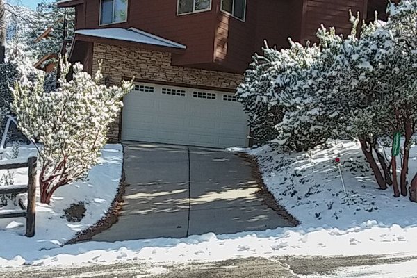 Heated Driveway in winter with snow melting system embedded in concrete