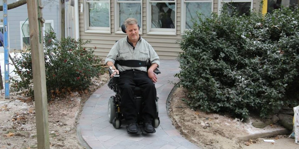 Rob Butts using completed heated wheelchair ramp in Hudson, MA showing successful snow melting system installation