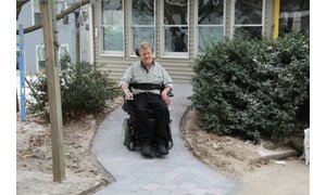 Rob Butts using completed heated wheelchair ramp in Hudson, MA showing successful snow melting system installation