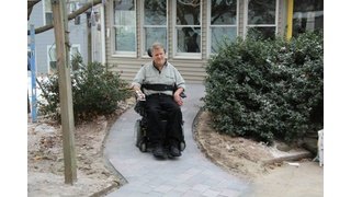 Rob Butts using completed heated wheelchair ramp in Hudson, MA showing successful snow melting system installation