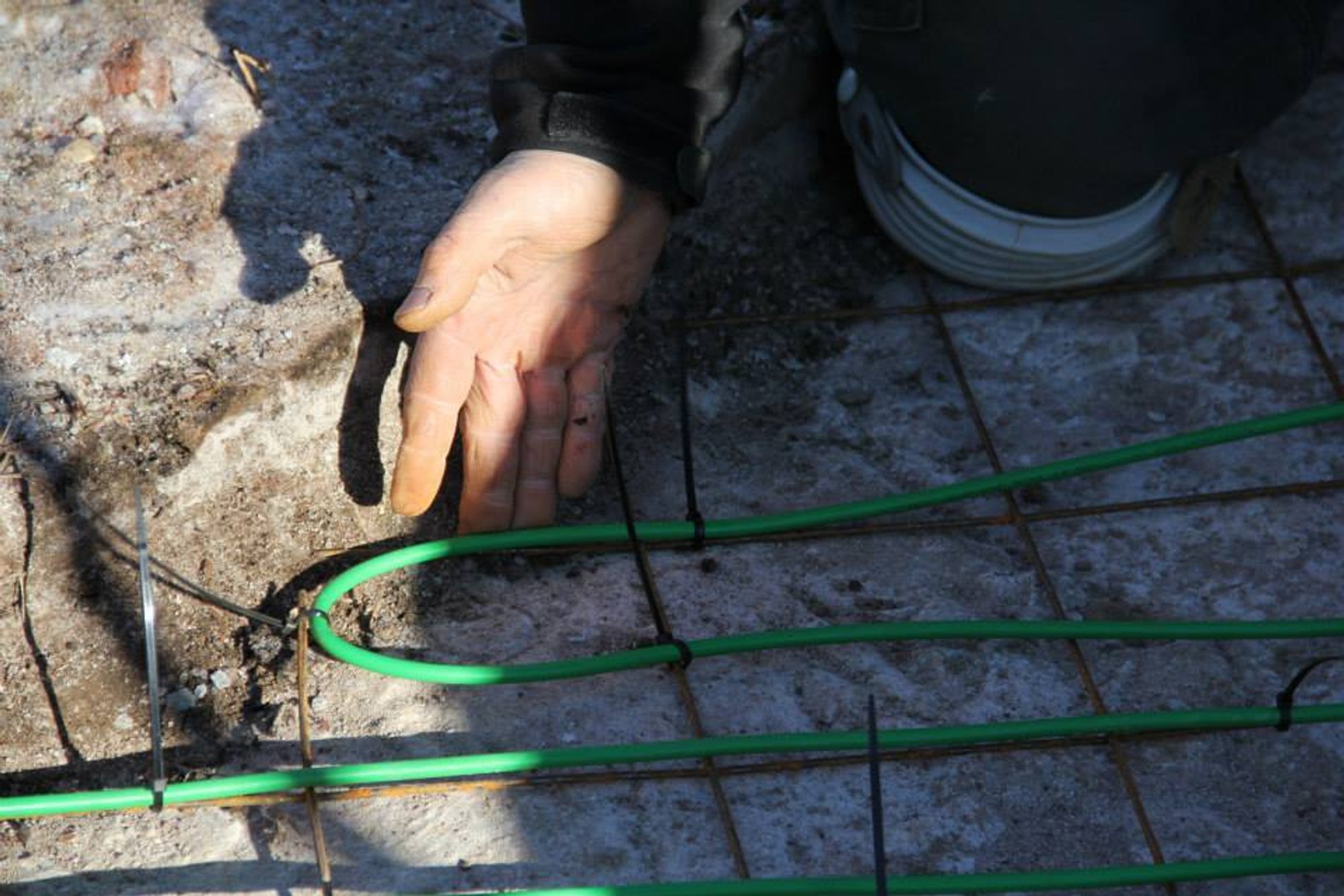 Detailed close-up of snow melting cable grid attachment method for heated wheelchair ramp installation in Hudson, MA