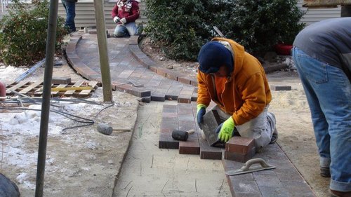 Brick paver removal for heated wheelchair ramp installation in Hudson, MA showing snow melting cable preparation