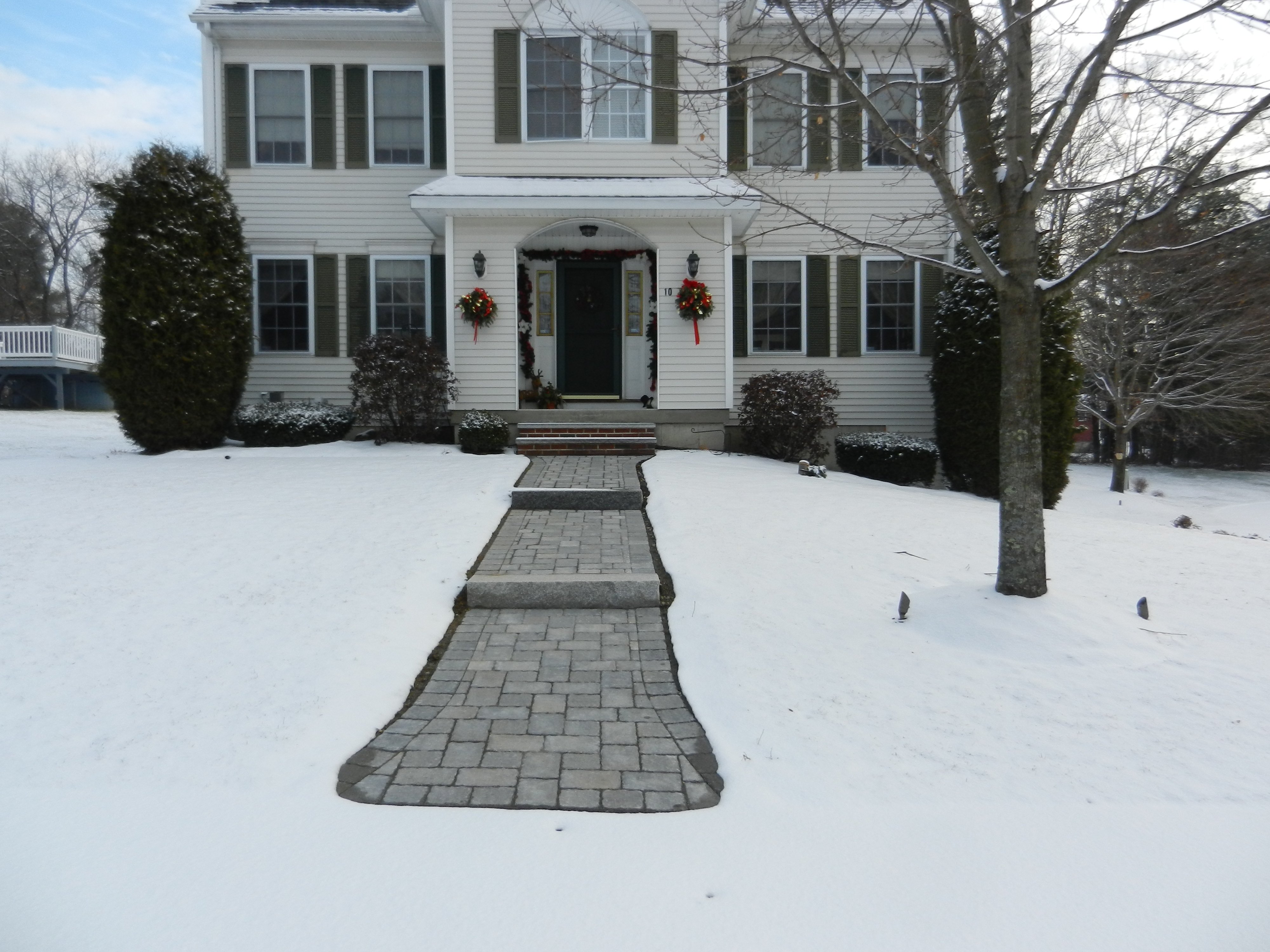 Heated paver walkway with snow melting mats during winter
