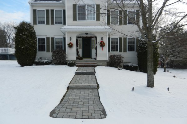 Heated paver walkway with snow melting mats during winter