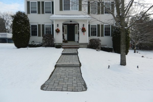 Heated paver walkway with snow melting mats during winter