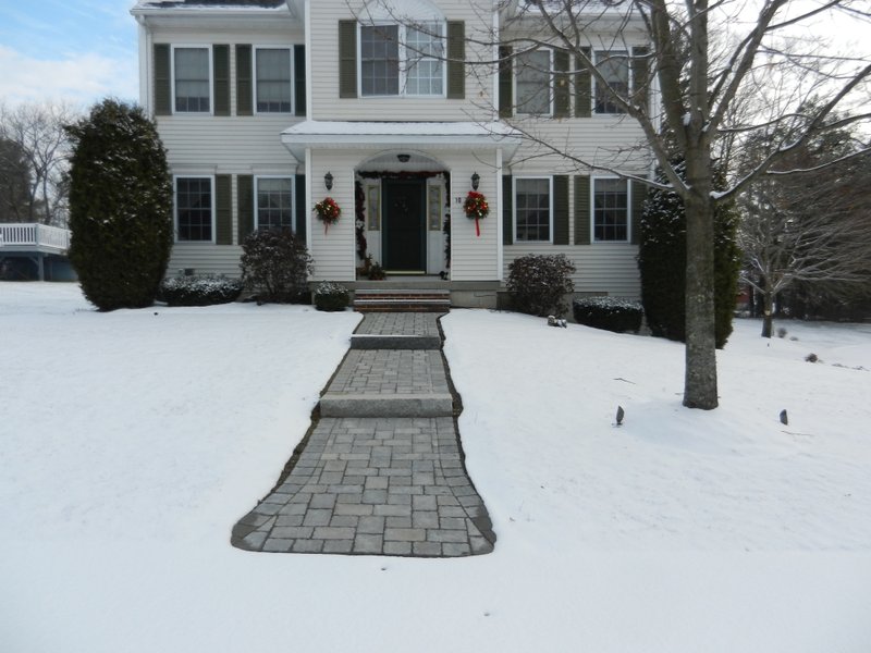 Heated paver walkway with snow melting mats during winter